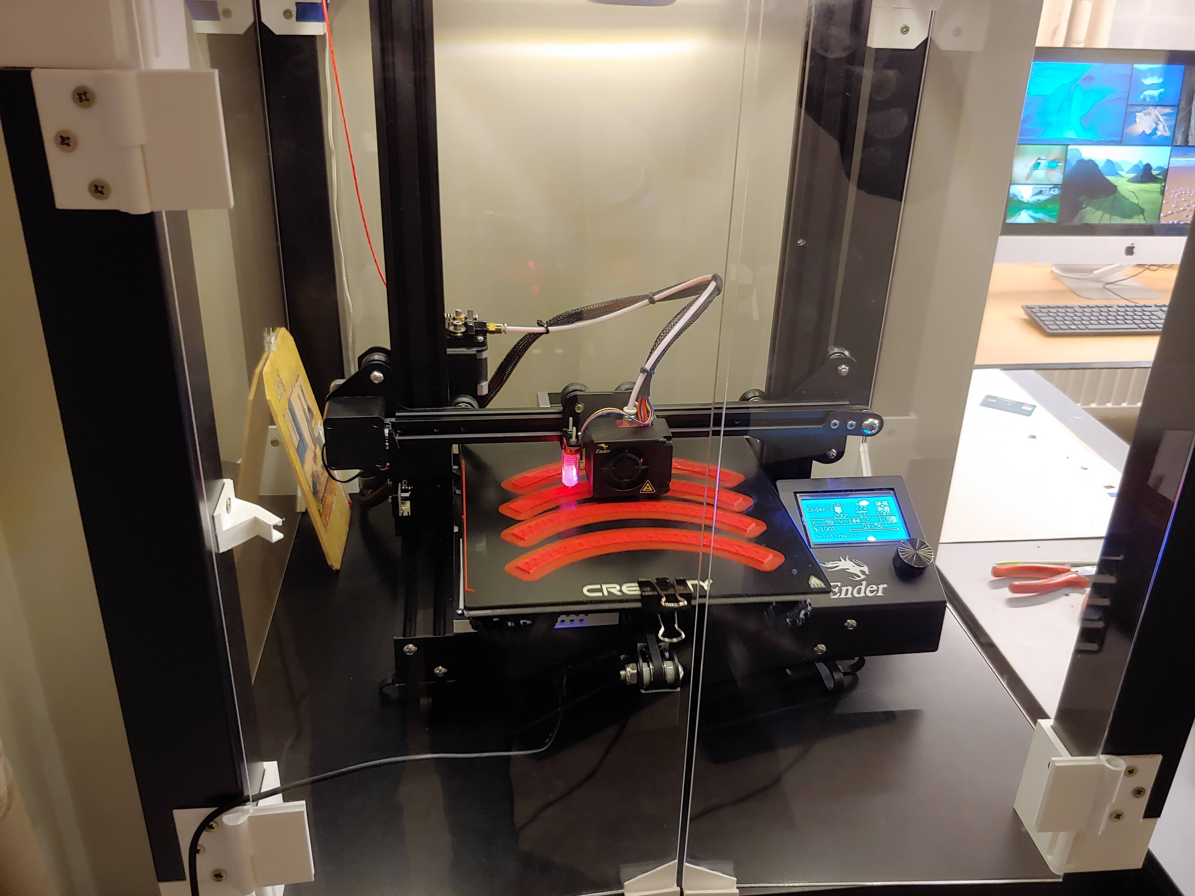 Ender 3 printing a batch of curved red components